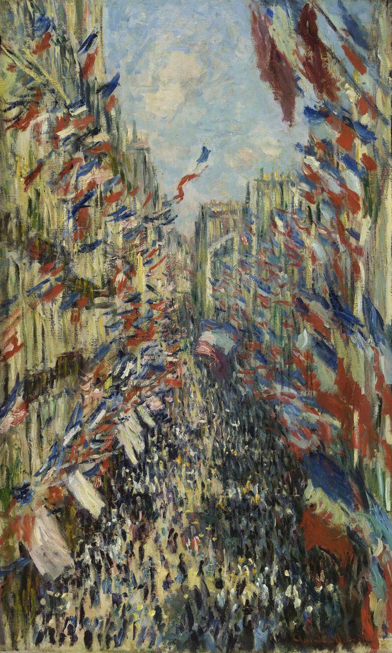 Flags fill the narrow Paris street with red, white and blue above a bustling crowd.