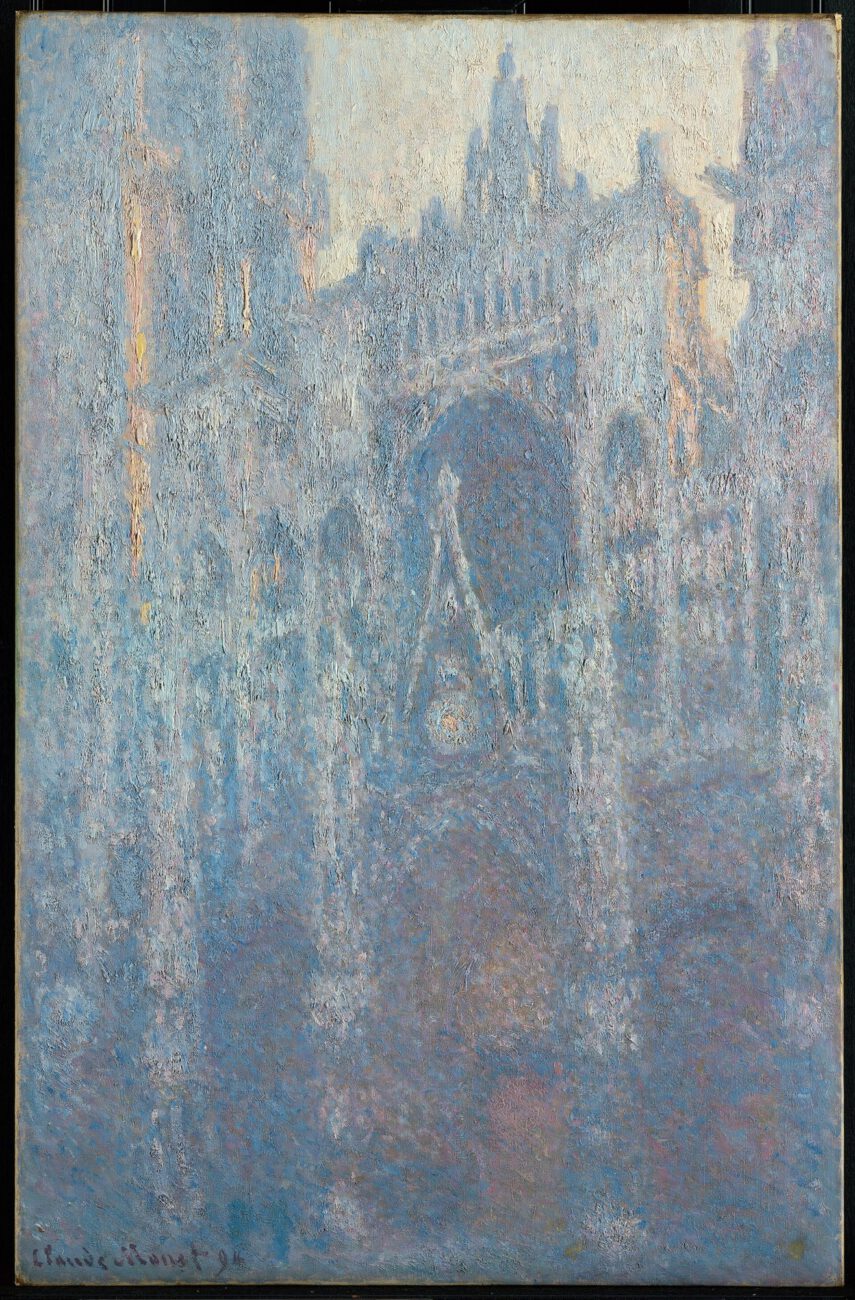Cool morning light softens the cathedral portal, with blue and violet shadows gathering around the stonework.