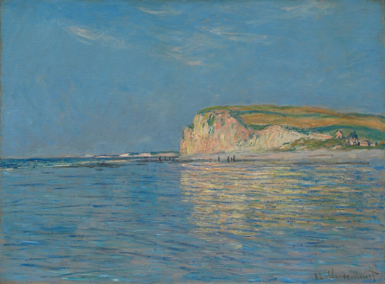 Pale coastal cliffs rise above a blue sea, with the shoreline stretching into the distance.
