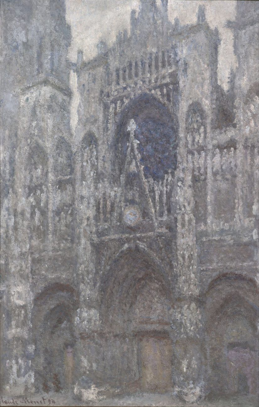Muted grey light reveals the deep arches and intricate stonework of the cathedral portal.